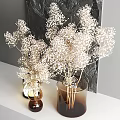 Brown Glass Vases With White Dried Flowers Against Dark Textured Wall And Small Lamp