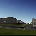 Modern Industrial Factory With Gray Exterior Green Lawn People Walking And Adjacent Building