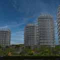 Modern Curved High Rise Hotel Buildings With Glass Facade Surrounded by Palm Trees And Greenery