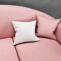 Pink Upholstered Three Seater Sofa with White Pillows against Gray Wall