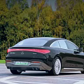 Luxury Black Mercedes-Benz Electric Sedan With Sleek Exterior Design And Green Forest