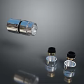 Metallic Transparent Cylindrical Components With Black Top Covers And Clear Bases