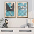 Two Framed Decorative Paintings With Living Room Shelf Decorations And Green Plant