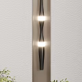 Modern Metallic Wall Lamp With Vertical LED Lights On Light Colored Wall And Gray Curtains