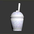 White Smoothie Cup With Colorful Speckles And Straw On Dark Shiny Surface