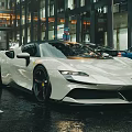 White Ferrari Sports Car On Wet City Street With Sleek Black Wheels
