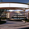 Modern Waterside Landscape With Circular Pavilion Reflective Pool Curved Pathway And Lush Greenery