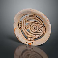 Intricate Ancient Circular Sculpture Carving with Geometric Patterns Eye Design and Pale Orange Speckled Openwork