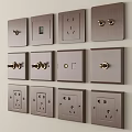 Metallic Bronze Switch Panels with Various Switches Sockets Neatly Arranged on Wall
