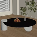 Modern Round Black Coffee Table with Fruit Bowl White Vase Green Plant on Wooden Floor