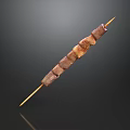 Tender Grilled Meat Skewer with Juicy Charred Pieces on Bamboo Stick