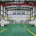 Industrial Factory Interior With Large Machinery Green Floor Yellow Lines Red Cranes And Blue Signs