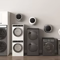 Multiple Washing Machines In Various Colors And Styles Arranged Against Wall With Round Devices