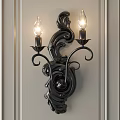 Ornate Black Wall Sconce With Curved Design And Double Bulbs On Gray Wall