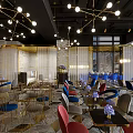 Modern Bar Interior Design With Open Layout Colorful Chairs Art Mural Chandeliers And Marble Tabletops