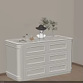 White Cabinet with Black Hat Perfume Plant in Beige Room with Window and Wooden Floor