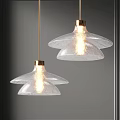 Modern Transparent Glass Petal Pendant Lights with Golden Metal Accents Illuminated Warm Light Grey Wall