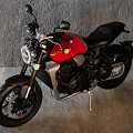 Modern Red and Black Motorcycle with Sleek Design Sporty Features in Gray Indoor Wall Setting