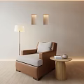 Modern Single Sofa With Light Colored Wall Wooden Floor Floor Lamp And Small Round Table