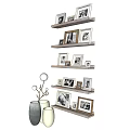 Various Decorative Photo Frames Arranged On Wall Shelves With Vases And Branch Decor