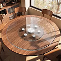 Round Wooden Dining Table Featuring Glass Turntable White Coasters and Wooden Chairs with Natural Light