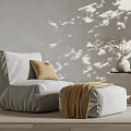 Gray Bean Bag Chair With Beige Cushion Brown Blanket Ottoman Side Table And Dried Branches