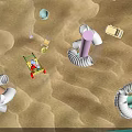 Cute Doll in Red Cart on Sandy Beach with Colorful Inflatable Rings and Beach Toys