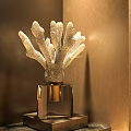 Coral Shaped Decorative Sculpture On Transparent Square Base With Warm Lighting And Brown Wall