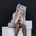 Woman With Silver Gray Long Hair And Pigtails In Black Lingerie Sitting On White Cube