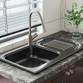 Black Double Bowl Kitchen Sink With Brushed Brass Faucet On Marble Countertop