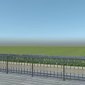 Decorative Metal Fence With Green Grass Blue Yellow Flowers Open Field And Blue Sky
