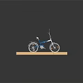 Blue and White Bicycle with Black Seat on Red Brick Floor Gray Background