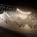 Evening Outdoor White Tents Setup With String Lights And Lawn Chairs