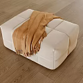 Cozy White Ottoman With Brown Blanket On Wooden Floor In Living Room