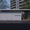 Modern Entrance Gate With Covered Structure And Green Plants Near High Rise Building