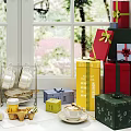 Decorative Ornament Set on Window Sill with Colorful Gift Boxes Teacups Plates and Green Plants