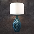 Blue Wavy Base Table Lamp With White Lampshade On Dark Textured Wall