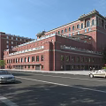 Scenic Modern Commercial Street With Red Brick Buildings Trees And Moving Cars