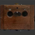 Vintage Electronic Device With Wooden Case And Metal Components Featuring Circular Holes And Knob