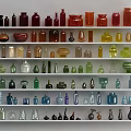 Ceramic Vessels of Various Colors and Different Shapes Displayed on Multiple White Shelves