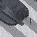 Modern Garden Landscape Design With Black Water Feature Paved Ground And Person Walking