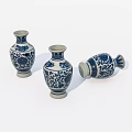 Traditional Blue and White Ceramic Vases with Intricate Floral Patterns Standing and Lying