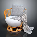 Cozy Rattan Chair with White Cushion Gray Geometric Pillow and Patterned Blanket