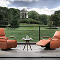 Orange Cozy Armchairs on Outdoor Terrace with Green Landscape and Small Round Table