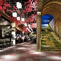 Cherry Blossom Decorated Restaurant Interior With Tables Chairs Arched Structure Staircase And Checkerboard Floor