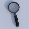 Handheld Magnifying Glass With Black Handle And Round Clear Lens On Light Background
