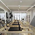 Bright Fitness Studio With Pilates Reformers Arched Mirrors And Plants
