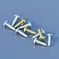 Scattered Silver And Gold Screws As Household Items On Blue Background