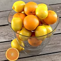 Fresh Oranges and Lemons in Glass Bowl on Pedestal with Sliced Orange and Wooden Table