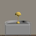 Yellow Mushroom Shaped Table Lamp With Round Base On Gray Cabinet And Light Wall Background